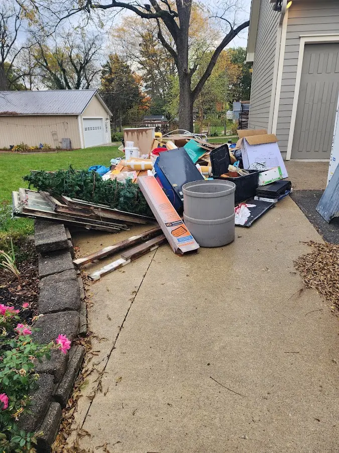 Dumpster being loaded with debris for Roofing Dumpster Rental in Dade City North